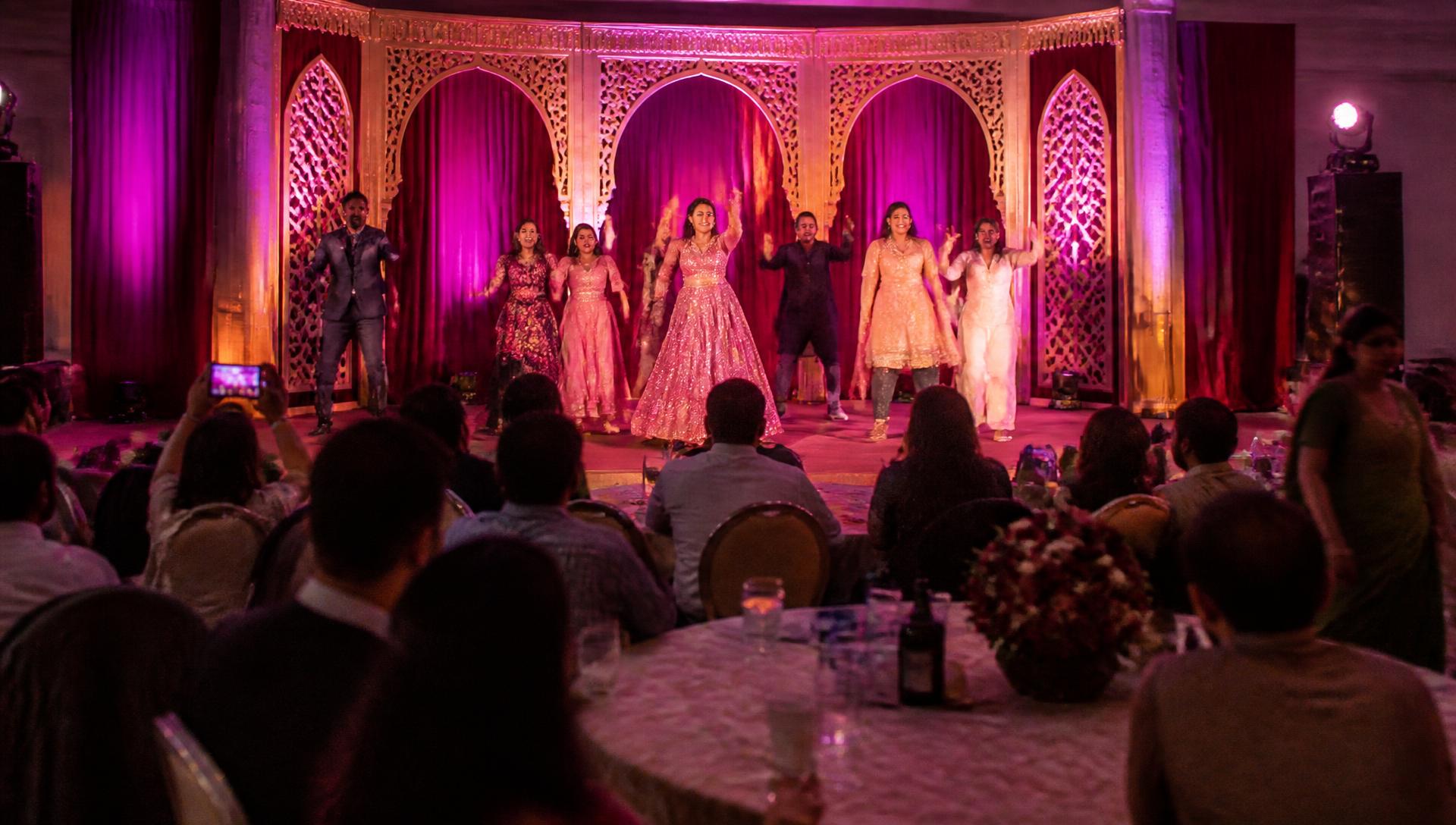 Family dancing on stage during a sangeet